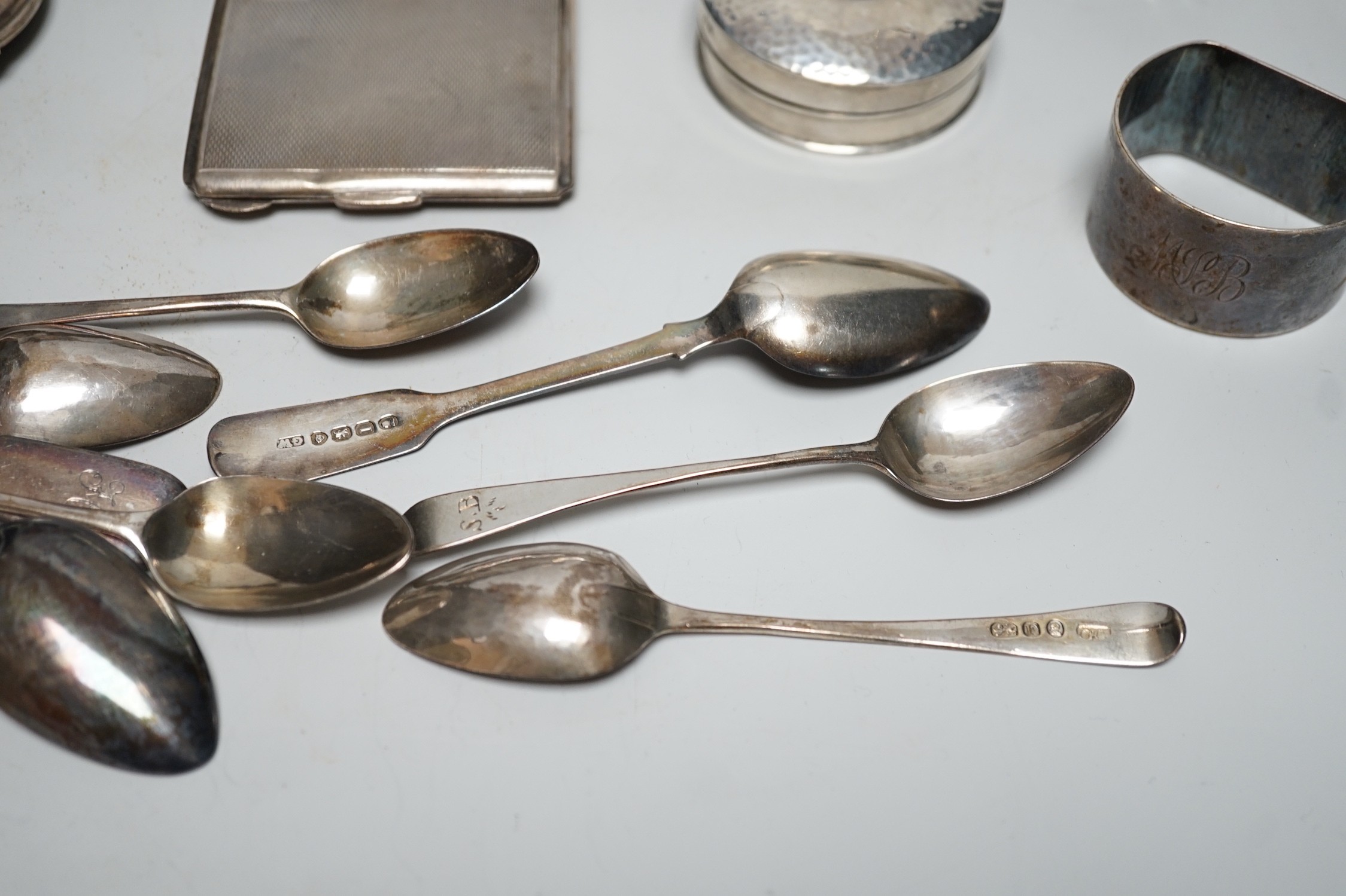 Sundry silver items, including a 1930's silver presentation cup, height 10.9cm, five silver or white metal mounted glass toilet jars, two silver napkin rings, two compacts, silver flatware and two Chinese white metal nap